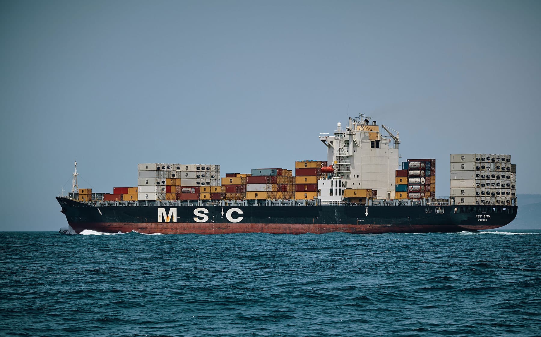 Container ship at port - NET LOGISTICS freight forwarding services